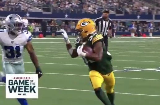 Green Bay Packer Aaron Jones flashes '915' after touchdown over Bills