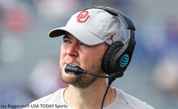 Lincoln Riley in a hat and headset