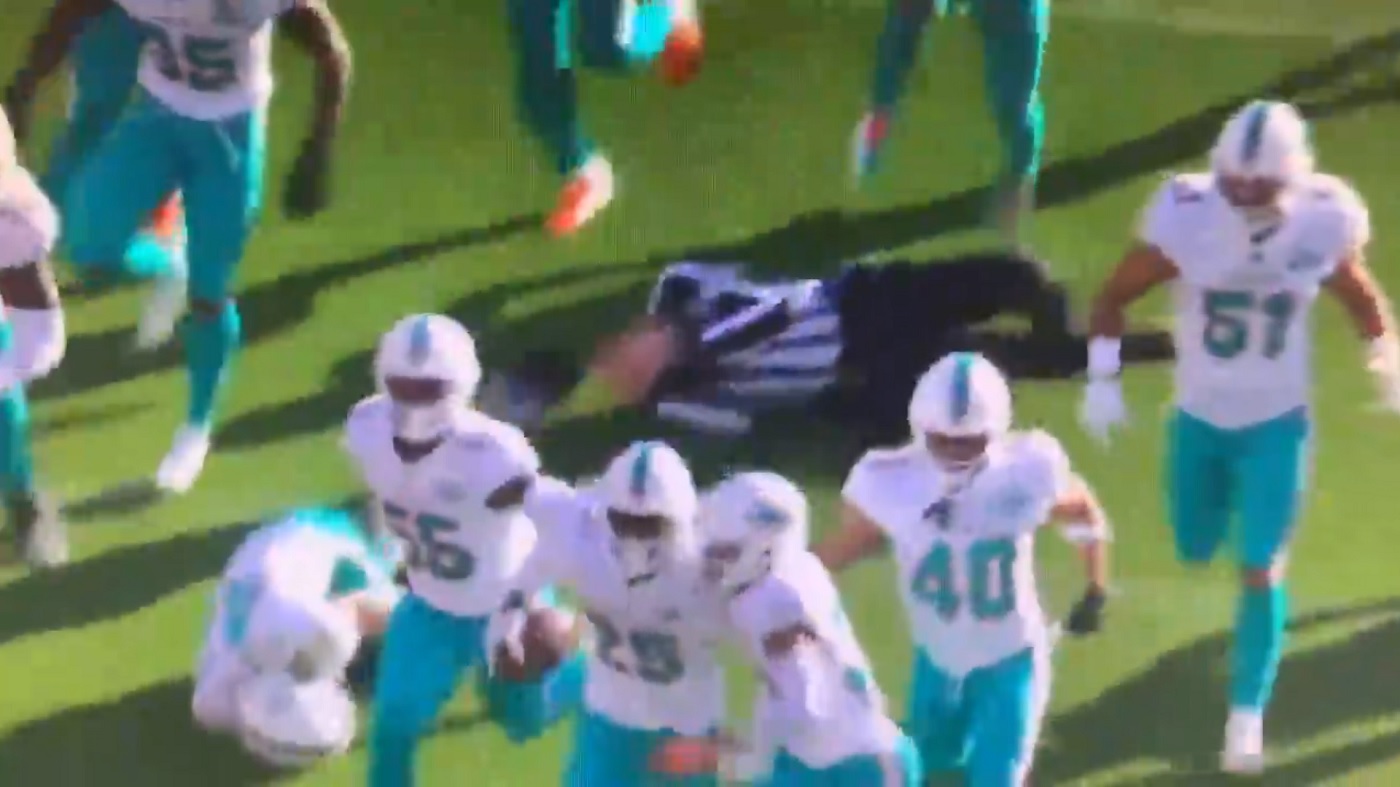 Video: Dolphins players run over referee celebrating interception