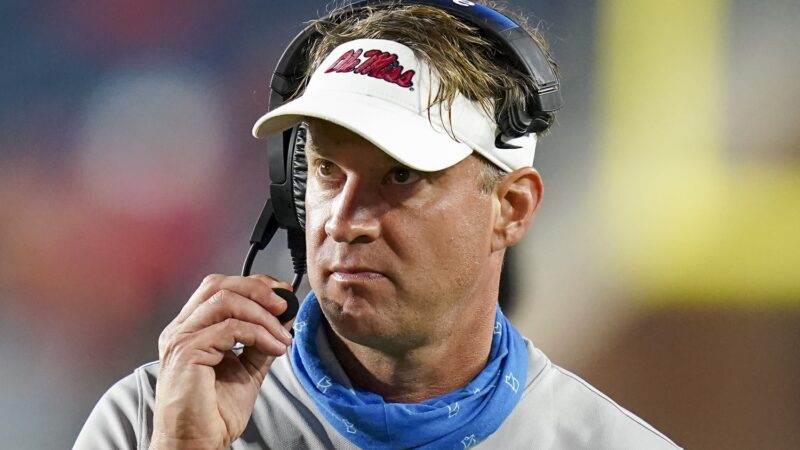 Lane Kiffin holds his headset