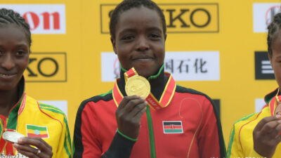 Agnes Tirop holds up a medal
