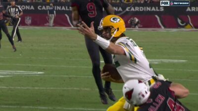 Aaron Rodgers appeals to ref for a call while being tackled