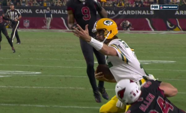 Aaron Rodgers appeals to ref for a call while being tackled