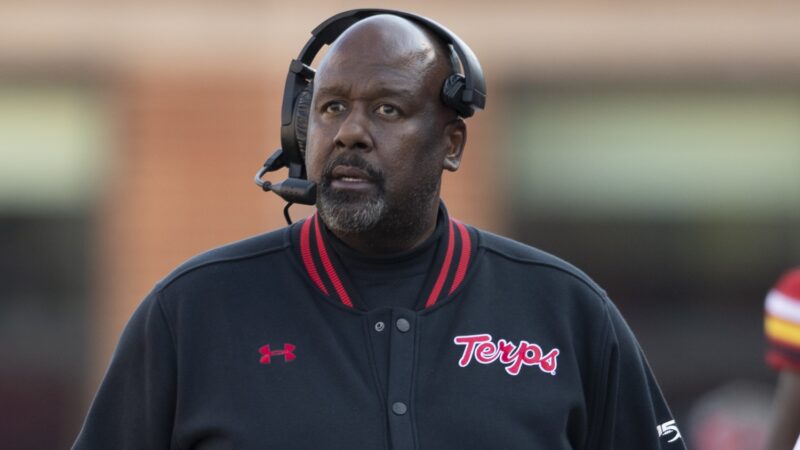 Mike Locksley wearing a headset