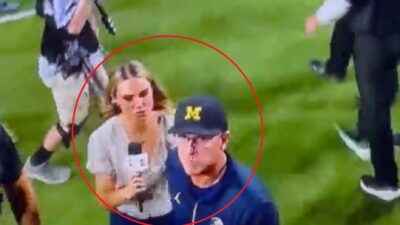 Molly McGrath holds a microphone near Jim Harbaugh
