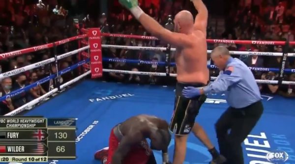 Tyson Fury raises his arms after a knockdown