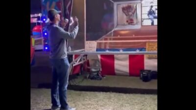 Adam Wainwright stands in front of a carnival game