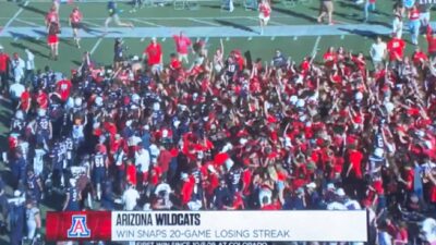 Arizona fans crowd the field