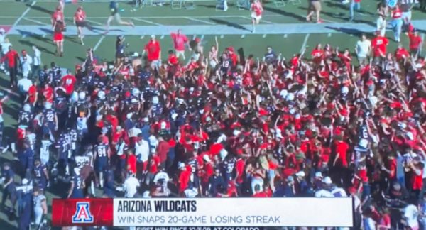 Arizona fans crowd the field