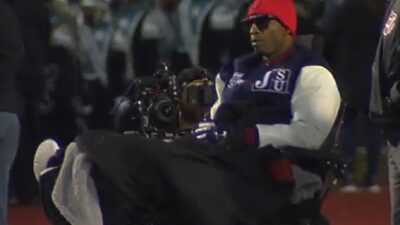 Deion Sanders in a motorized wheelchair