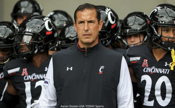 Luke Fickell stands in front of his players