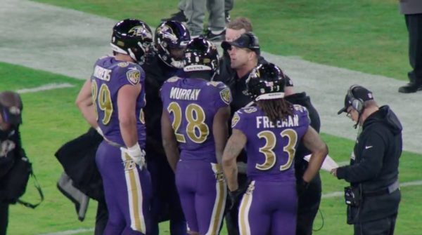 John Harbaugh huddles with his players