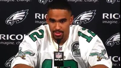 Jalen Hurts wears a Randall Cunningham jersey