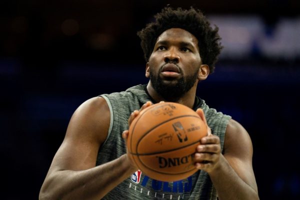 Joel Embiid holds a basketball