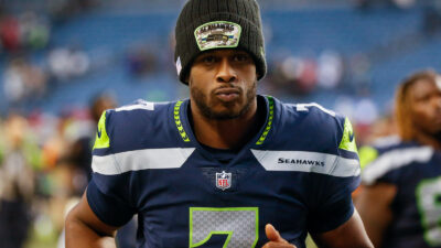 Geno Smith jogs onto the field