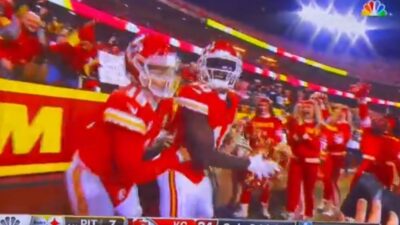 Tyreek Hill holds pom poms
