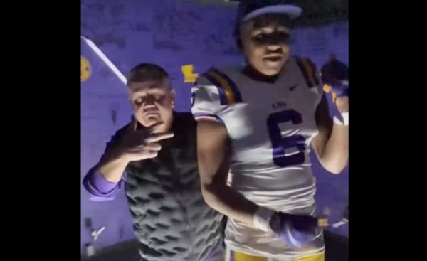 Brian Kelly dances with a recruit