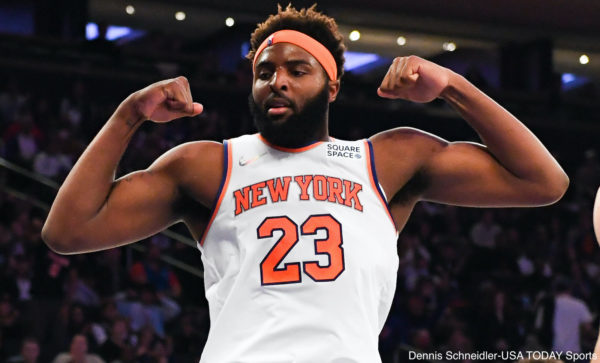Mitchell Robinson flexes during a game