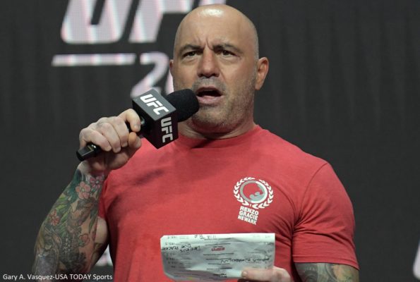 Joe Rogan holds a mic