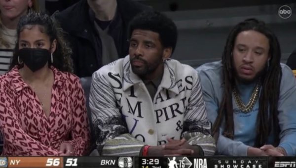 Kyrie Irving sits courtside