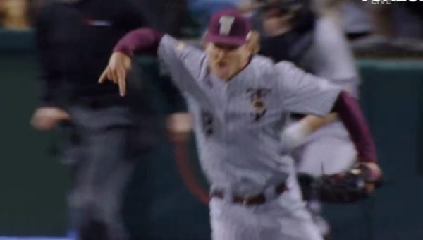 A Texas State player flashes Horns Down