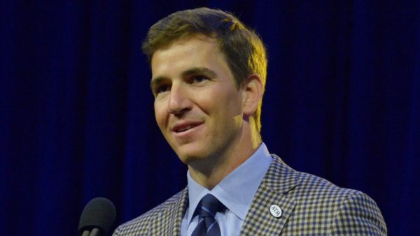 Eli Manning in a coat and tie