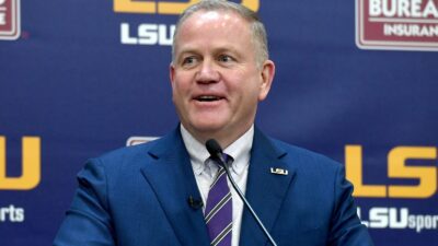 Brian Kelly smiles at an LSU press conference