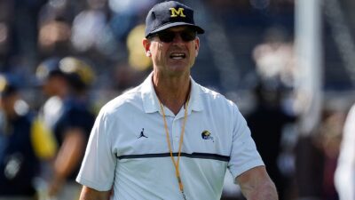 Michigan head coach Jim Harbaugh walking