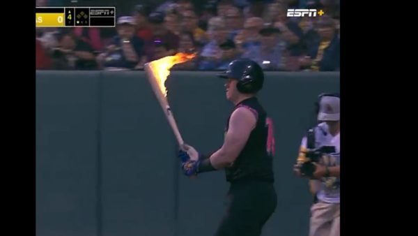 Zak Whalin holds a flaming bat