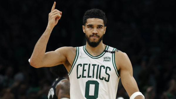 Jayson Tatum puts his hand in the air