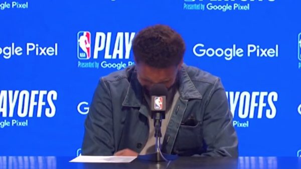 Klay Thompson laughs at a press conference