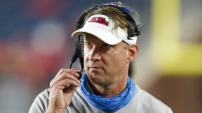 Lane Kiffin holds his headset