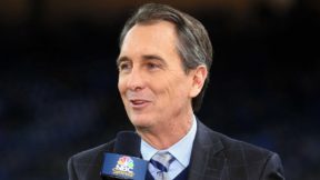 Cris Collinsworth holds a mic