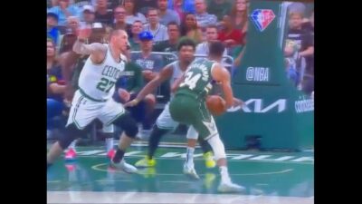 Giannis Antetokounmpo holds the ball