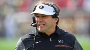 Kirby Smart with a headset and Georgia visor