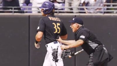An umpire pushes Bryson Worrell