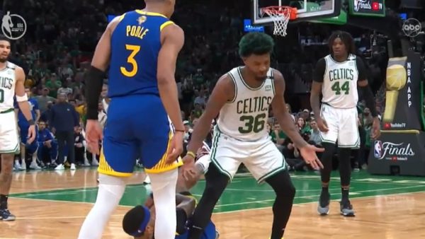 Marcus Smart stands near Jordan Poole