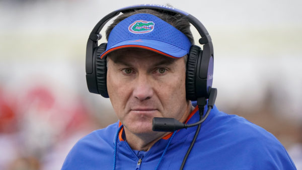 Dan Mullen wearing a headset.