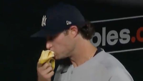 Gerrit Cole scarfing down a banana in the dugout.