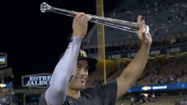 Giancarlo Stanton holds up a bat