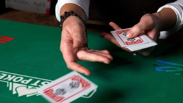 A poker dealer handing out cards