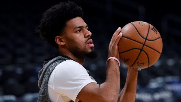 Quinn Cook holding a basketball