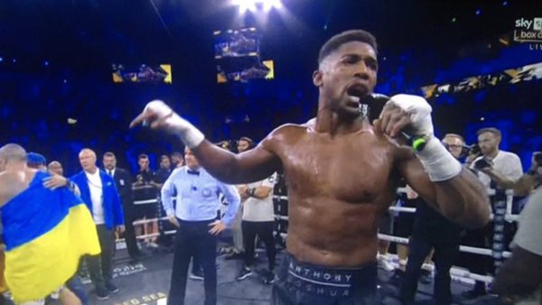 Anthony Joshua holds the mic