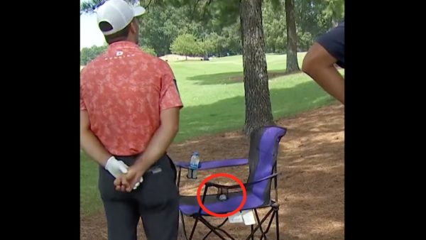 Denny McCarthy surveying the tee shot he hit into the cupholder of a patron.