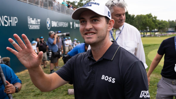 Patrick Cantlay waves to fans