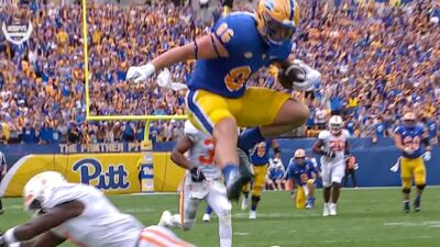Gavin Bartholomew hurdles a man