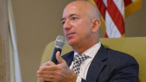 Jeff Bezos holds a microphone