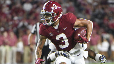Jermaine Burton tries to break a tackle