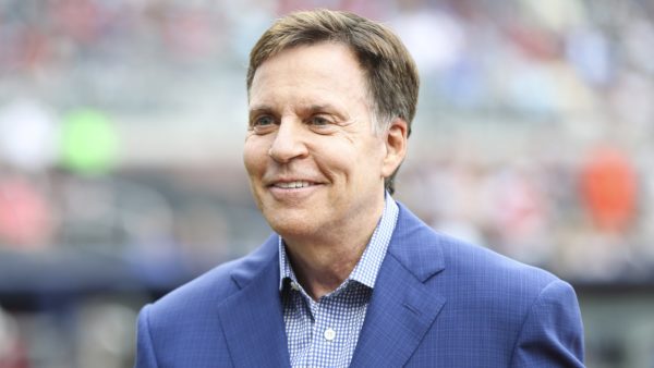 Bob Costas smiling on the field