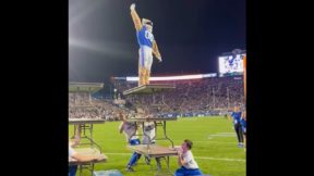 The BYU mascot stands atop a table
